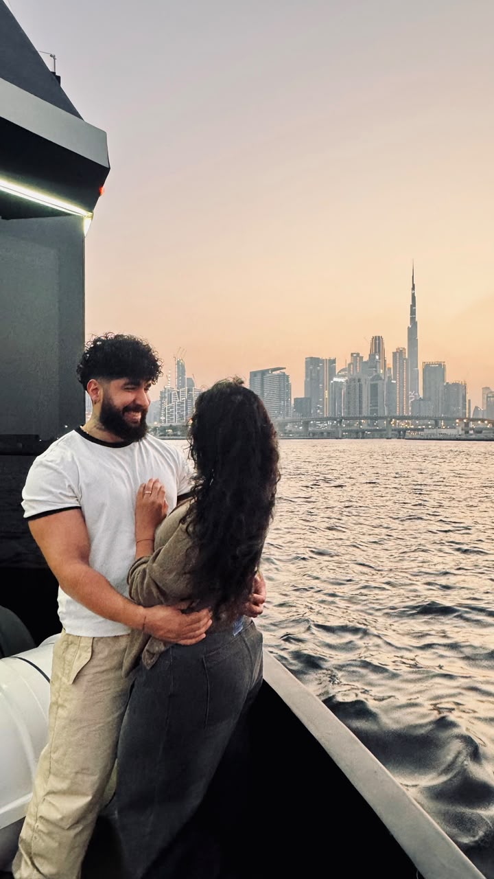 Sadaf and Arash on a boat with the Dubai skyline at sunset